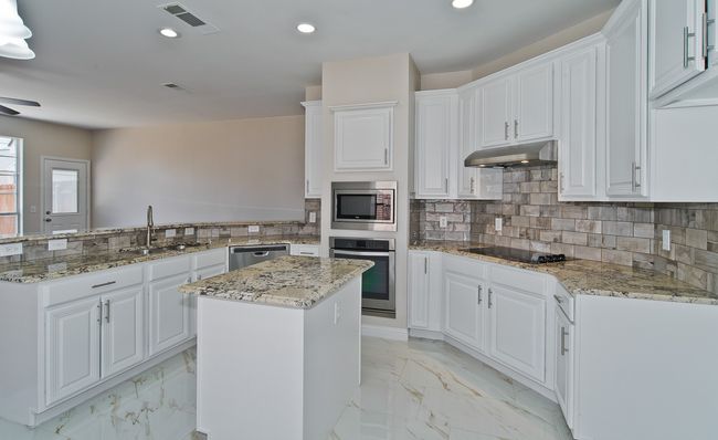 Beautiful White Cabinetry And New Backsplash Adorn The Chef's Kitchen. | Image 14