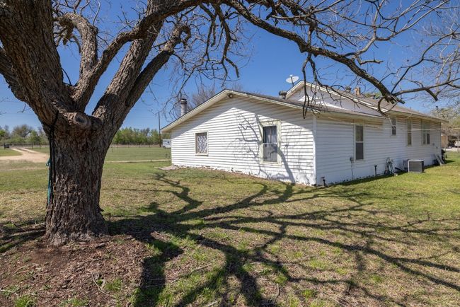View of property exterior with central AC unit and a yard | Image 6