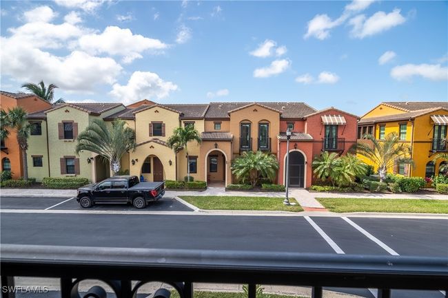 View of front of property with a residential view, uncovered parking, a tiled roof, and stucco siding | Image 30