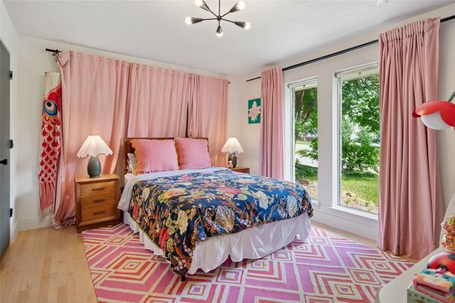 Guest bedroom with two closets overlooks front lawn. | Image 16