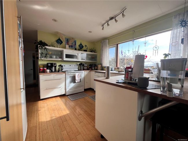 Upstairs unit kitchen with butcher block cabinets and wood flooring | Image 4