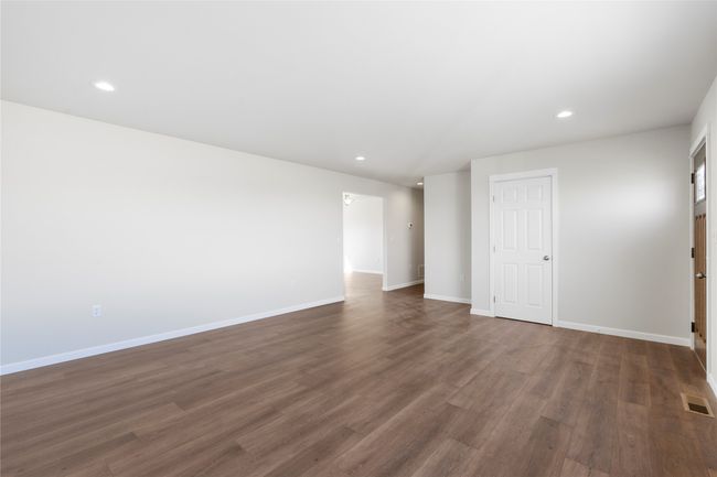 Unfurnished bedroom with baseboards, dark wood-style floors, visible vents, and recessed lighting | Image 33