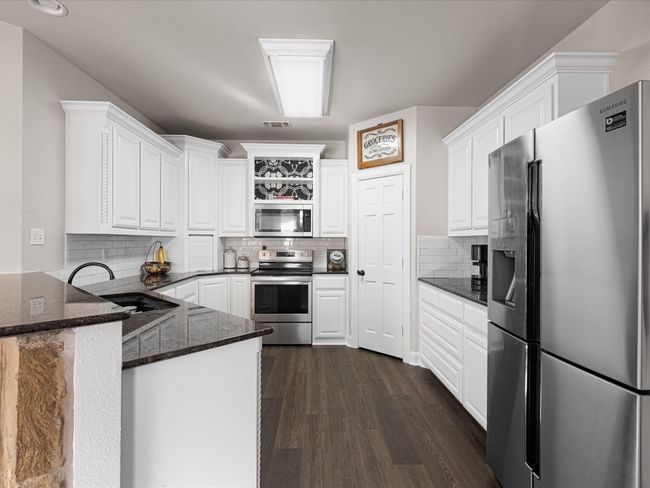 Spacious kitchen with granite counters, stainless steel appliances and a walk in pantry | Image 8