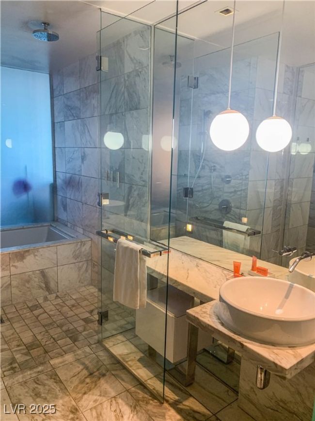Bathroom featuring a shower stall and tiled bath | Image 7