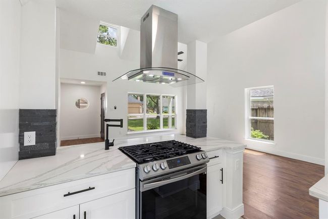 Chef's kitchen boasts updated appliances, gorgeous quartz counter tops, convenient pot filler, and well-crafted soft close cabinets throughout. | Image 8
