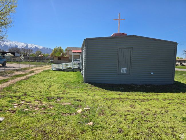 View of outdoor structure featuring an outdoor structure, a mountain view, and fence | Image 17