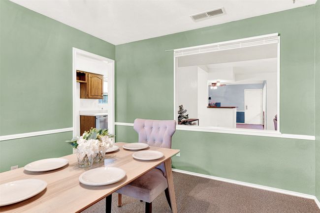 Dining area with carpet flooring and baseboards | Image 8