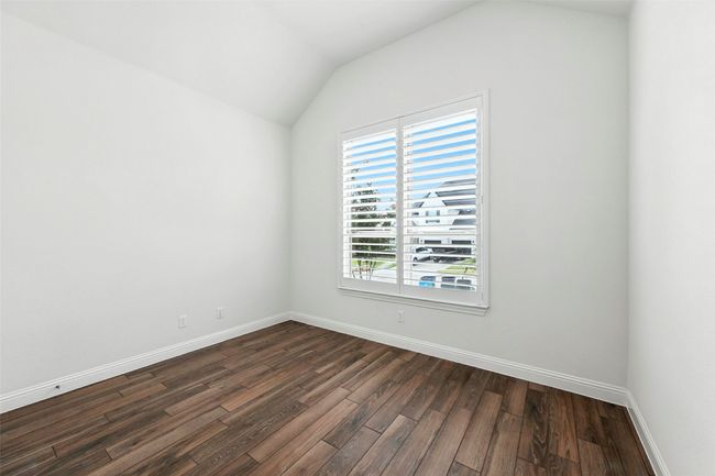 Spare room with tile floors and lofted ceiling | Image 26