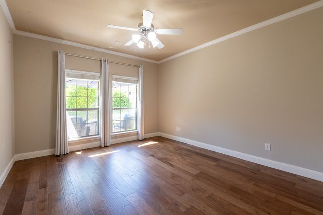 Primary bedroom also has engineered hardwood floor and pretty views. | Image 9