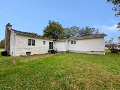 View of front of property with central air condition unit and a front yard | Image 2