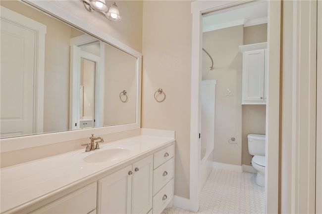 Full bath with toilet, vanity, tub / shower combination, and baseboards | Image 21