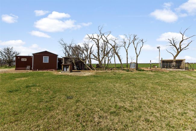 View of yard with exterior structure and an outbuilding | Image 17