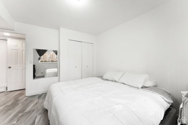 Bedroom with wood finished floors and a closet | Image 8