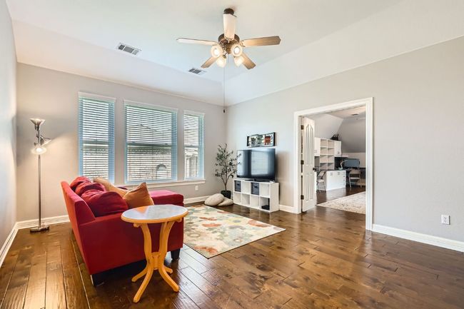 Upstairs living area with hardwood flooring, ceiling fan, lofted ceiling | Image 21