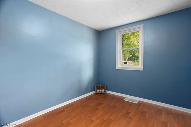 Wood floored spare room with a textured ceiling | Image 16