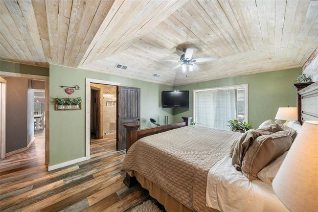 An additional perspective of the expansive primary bedroom, seamlessly into the ensuite bathroom. | Image 28