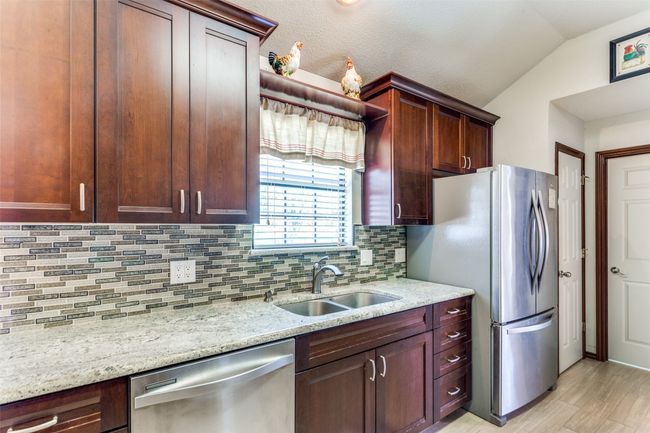 Window over the sink, doors to pantry and laundry room | Image 13