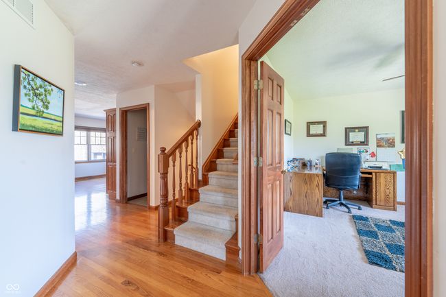 stairs with baseboards, wood finished floors, and visible vents | Image 20