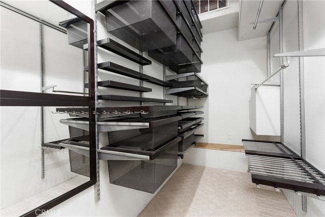 Off master suite, walk-in closet #1 has custom shelving and storage solutions | Image 38