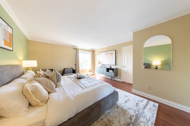 Bedroom featuring baseboards, crown molding, and wood finished floors | Image 31