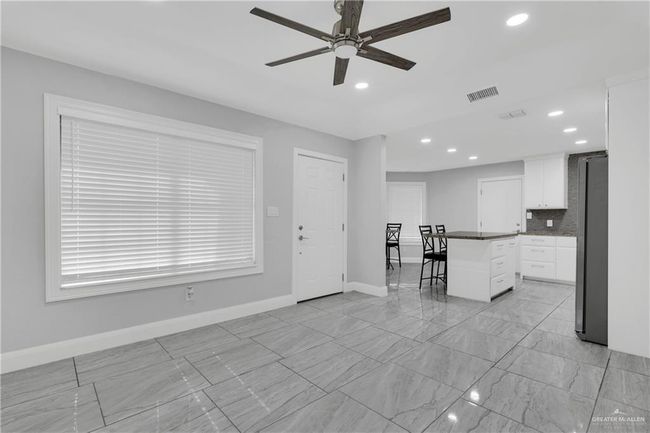 living room area with view to kitchen | Image 14
