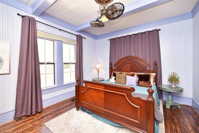 The primary bedroom is a great size. The custom shades are on a remote control. The fan looks original but is newer. | Image 9