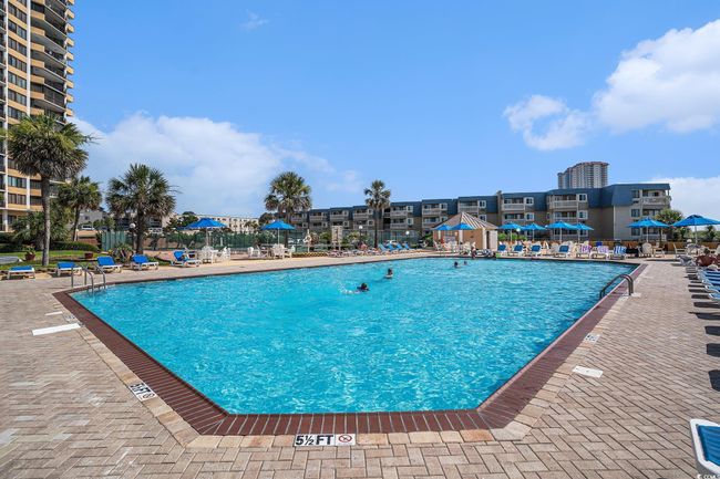 Community pool with a patio | Image 36