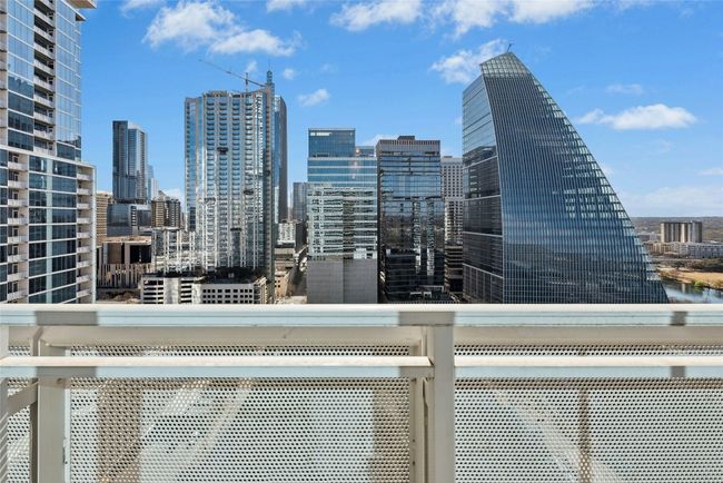 View of patio featuring a city view, exterior kitchen, outdoor dining area, and a grill | Image 16