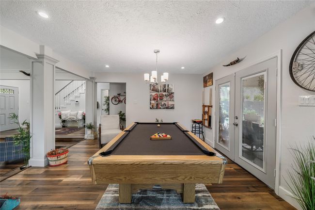 This versatile space, perfect for dining or entertaining, features French doors opening to the backyard. | Image 5