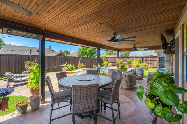 Fenced backyard featuring a patio area, outdoor dining space, and a ceiling fan | Image 34