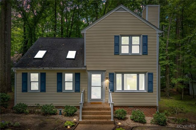 View of front facade featuring entry steps, a chimney, and roof with shingles | Image 7