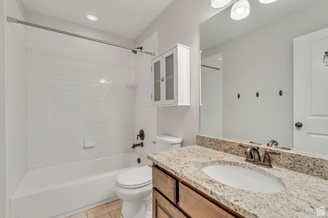 Main floor hallway bathroom with granite countertops. | Image 12