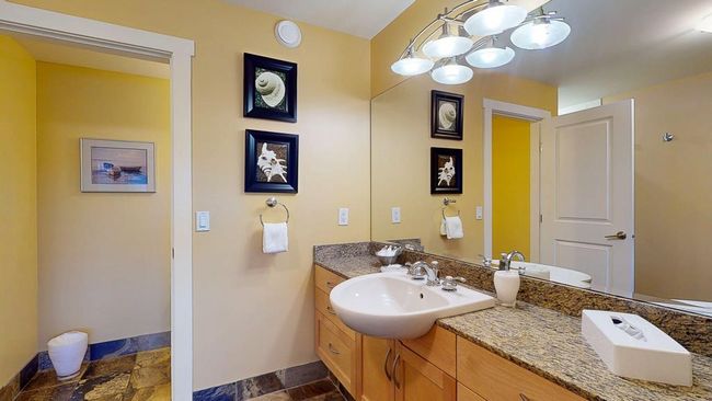 Bathroom with baseboards, vanity, and stone finish floor | Image 22