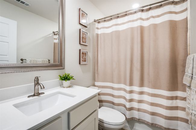 Bathroom with vanity and a shower with curtain | Image 19