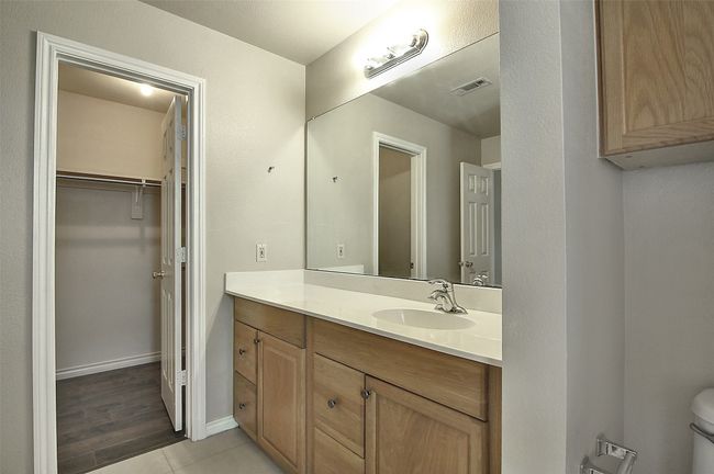 Bathroom with tile patterned flooring, vanity, and toilet | Image 15