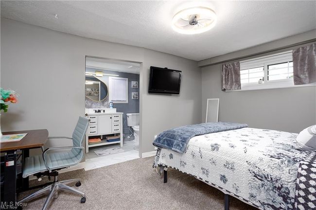 Bedroom featuring ensuite bathroom, baseboards, and carpet | Image 9