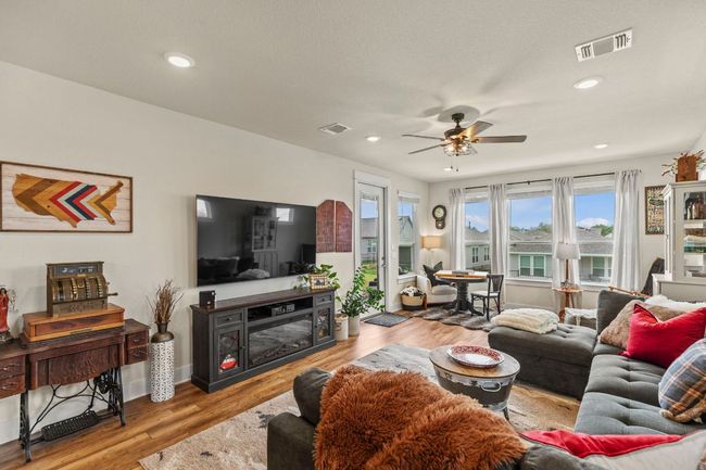 Living area featuring wood finished floors, visible vents, recessed lighting, and ceiling fan | Image 16