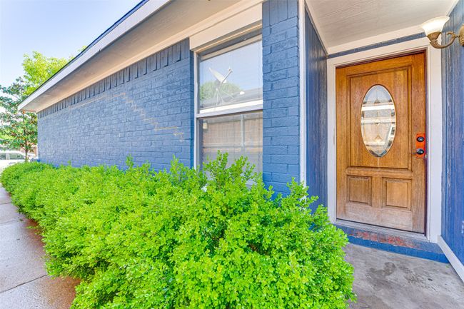 View of exterior entry with brick siding | Image 22