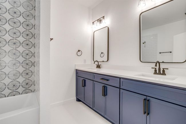 Bathroom featuring a shower, a bathing tub, double vanity, and a sink | Image 26
