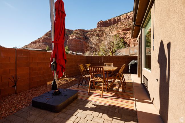 View of patio featuring a fenced backyard, grilling area, outdoor dining area, and a mountain view | Image 30