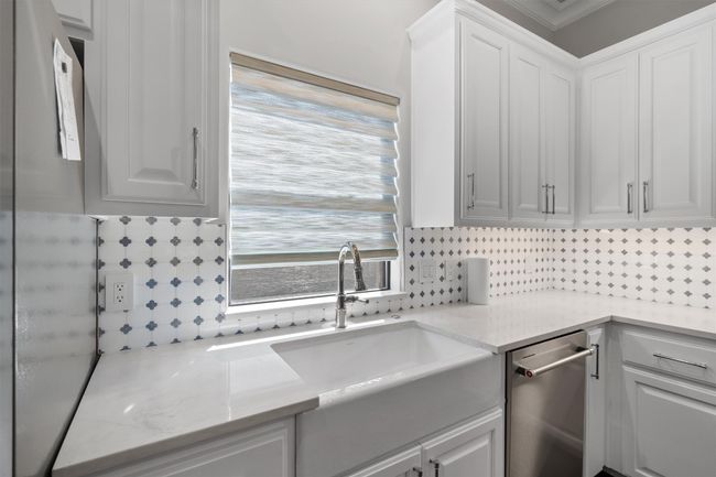 Clothes washing area featuring a sink and ornamental molding | Image 9