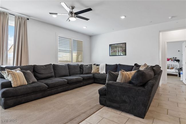 Living area featuring light tile patterned floors, plenty of natural light, ceiling fan, and recessed lighting | Image 13