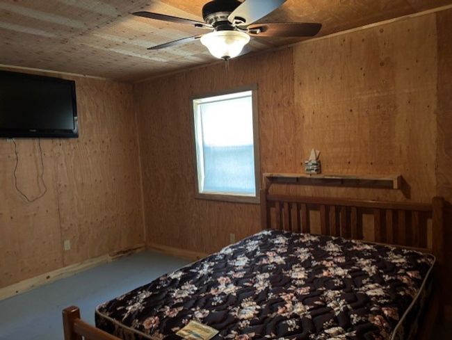 Bedroom featuring wooden walls | Image 18