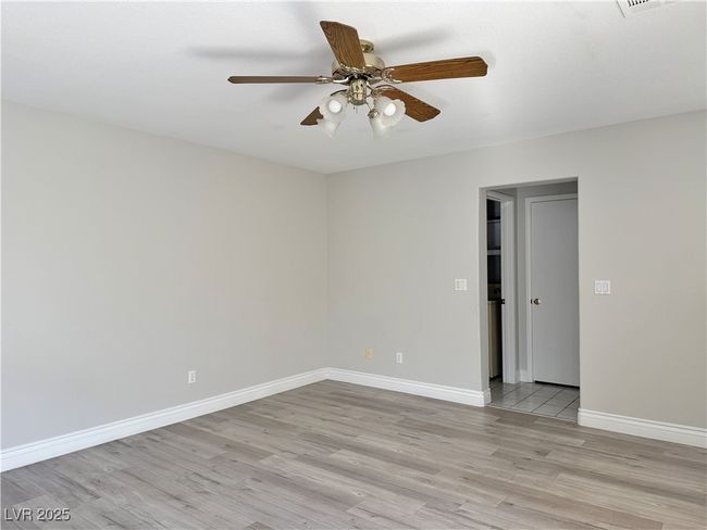 Spare room with baseboards, light wood finished floors, and ceiling fan | Image 17