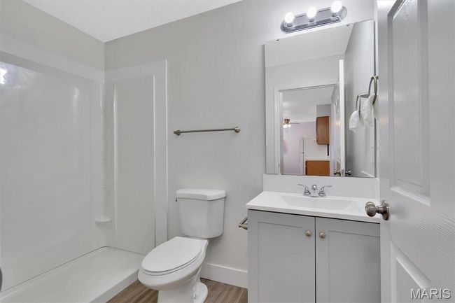 Bathroom with vanity, toilet, LVP floors, and a shower | Image 10
