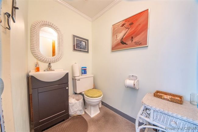 Half bath with ornamental molding and vanity | Image 4