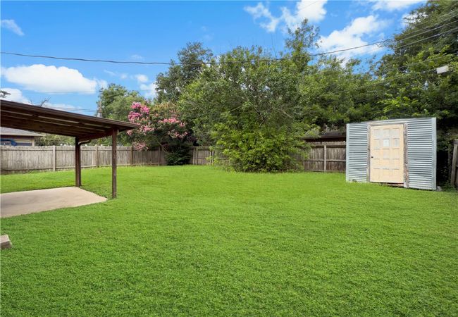 Fenced backyard featuring a storage unit and a patio | Image 19