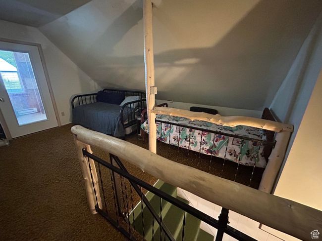 Carpeted bedroom featuring vaulted ceiling | Image 29