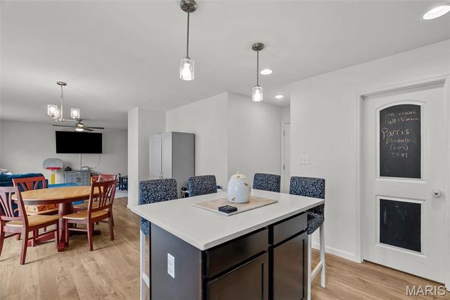 Kitchen with fridge, stove, dark cabinetry, light countertops, and recessed lighting | Image 27