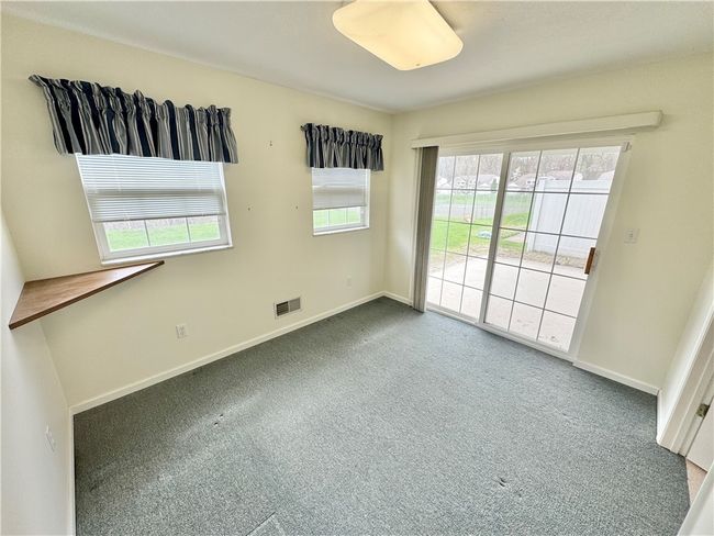 The first floor den is located off the master bedroom. The sliding glass door gives access to the rear covered patio. | Image 15